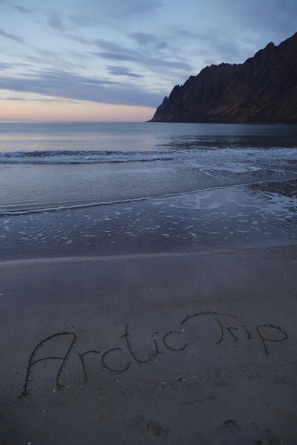 Arctic Trip written in the sand on a beach