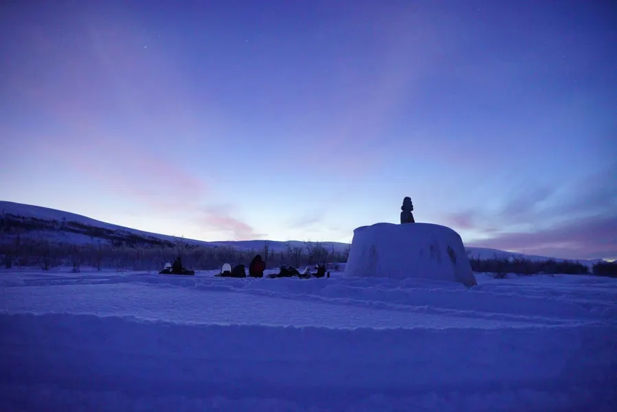 A snow shelter on a plateau at blue hour